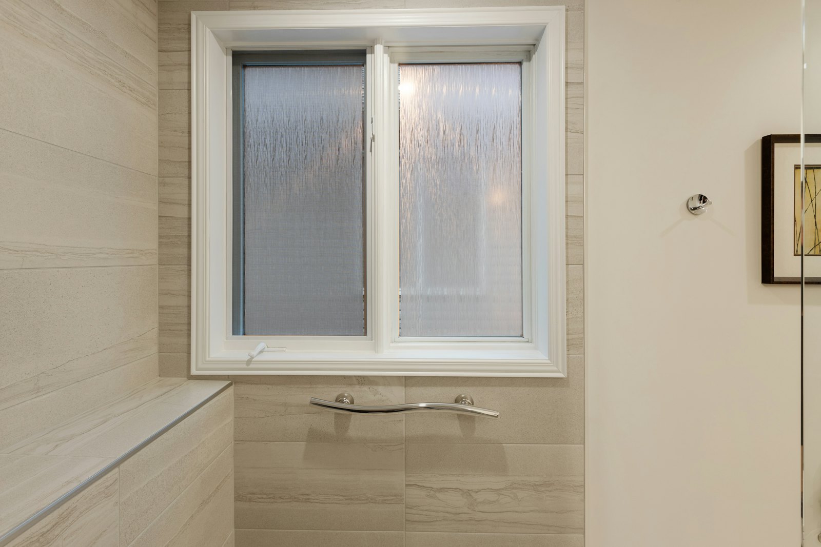 White window with a handle in a tiled room